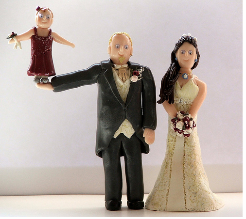 Unique cake topper of Bride and Groom and Acrobatic Flower Girl.PNG