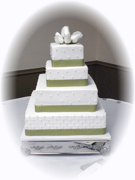 photo square wedding cake with green ribbons with flowers top