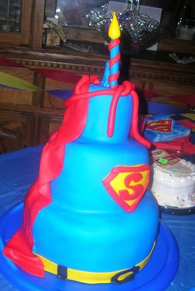 Blue 3 tier Superman theme cake with red cape.JPG