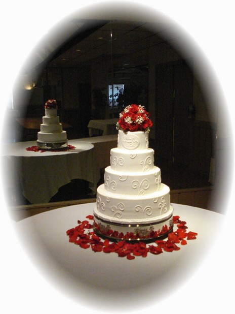elegant wedding cake with red flowers