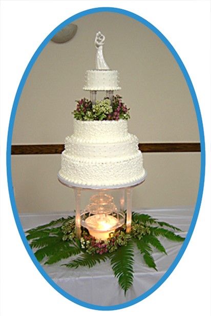 traditional white wedding cake with four tier photo