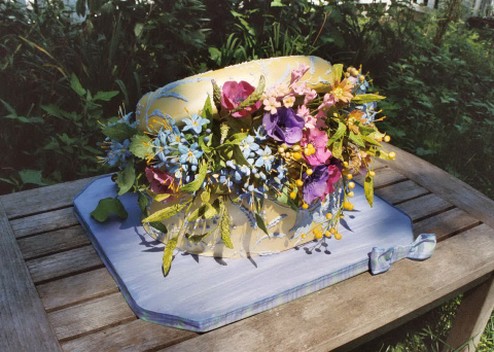backet shaped wedding cake with colorful flowers