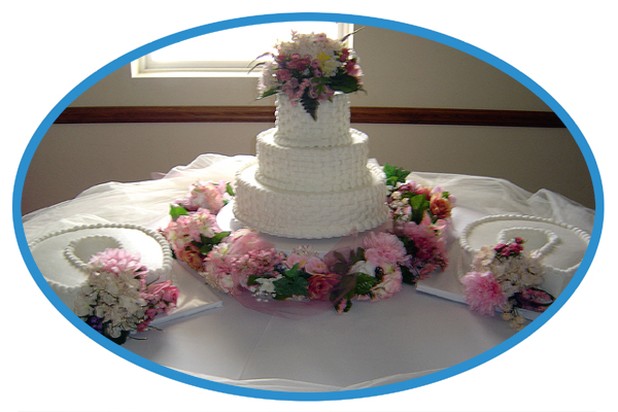 white three tier wedding cake with colorful flowers