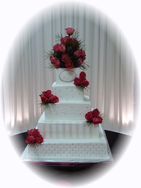classic sqaure style wedding cake with red roses