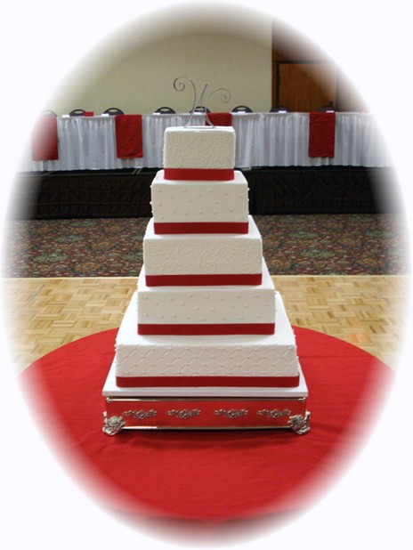 trendy square wedding cake with red ribbons