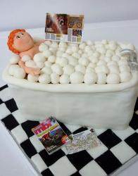 Red hair woman relaxing in bubble bath with magazines cake.JPG