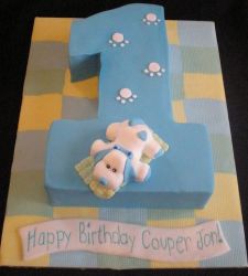 Cute first birthday cake in shape of the number one with pink puppy on top.JPG