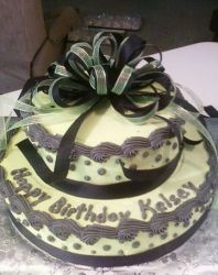 Two tier birthday cake with black bow and velvet cream.JPG