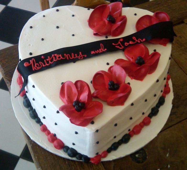 White heart-shaped bridal shower cake with red flowers.JPG
