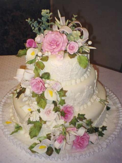 simple wedding cake with full of fresh flowers