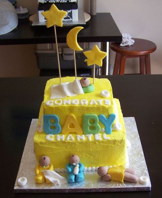 Two tier yellow baby shower cake with four babies.JPG