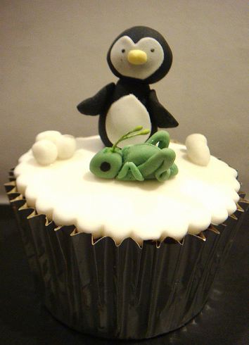 White cupcake with penguin and grasshopper topper.JPG