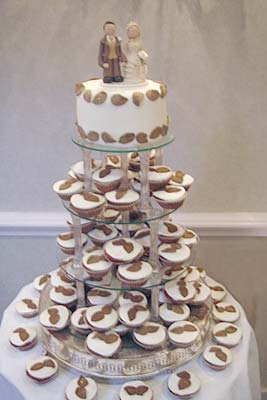 Wedding cup cakes with groom and bride toppers picture