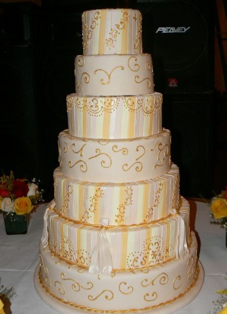 7 tier wedding cake with gold trim.JPG