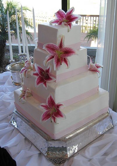 Four tier white rectangular wedding cake with fresh flowers.JPG