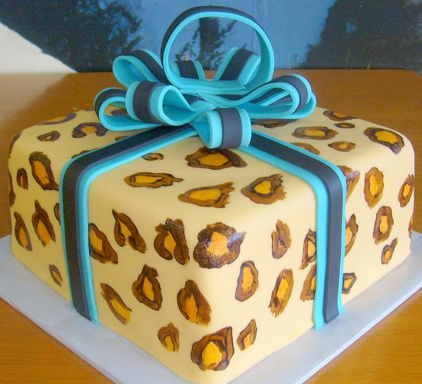 Gift box cake with blue bow and leopard spots.JPG