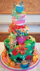 Four tier creative Alice in Wonderland theme cake with tea cup and fish on top.JPG