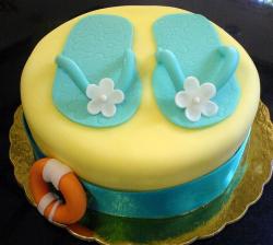 Yellow round cake with blue sandals and orange lift float.JPG