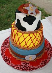 Three tier cowboy theme cake with hat and belt buckle.JPG