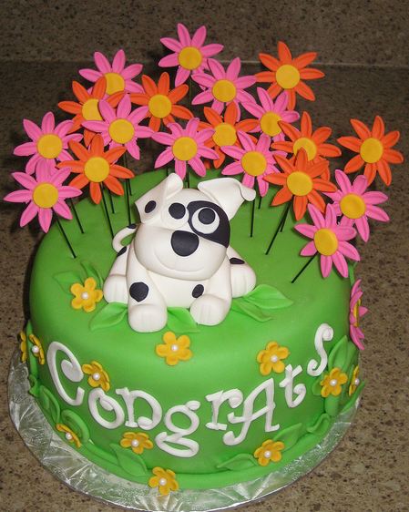 Greeen round cake with puppy in a flower field.JPG