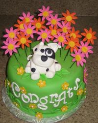 Greeen round cake with puppy in a flower field.JPG