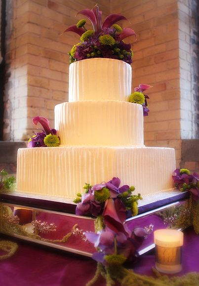 3 tier fluted butter cream wedding cake with flowers.JPG