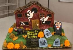 Haunted house theme Halloween birthday cake with Dracula and ghosts and tombstones.JPG