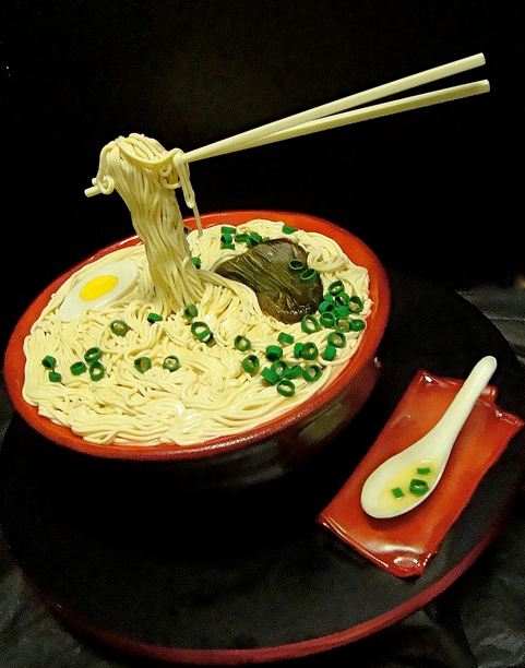 Asian soup noodles cake with chopsticks and spoon.JPG
