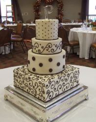 Four tier white cake with chocolate accent.JPG