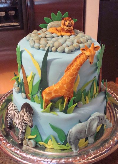 Two tier safari theme cake with lion giraffe zebra and elephant.JPG