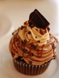 Chocolate cream mocha cupcake topped with nuts and chocolate bits.JPG