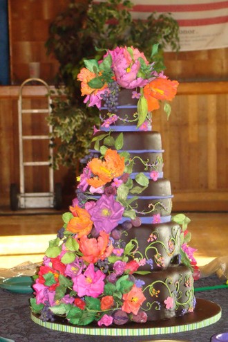 dramatic chocolate wedding cake with colorful flowers pics