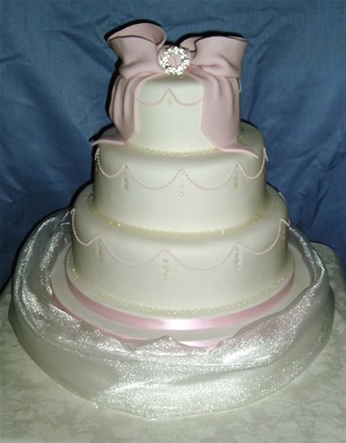 three tier wedding cake with light pink bows