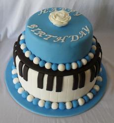 Two tier piano theme birthday cake with blue and white beads.JPG