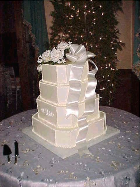 shinny wedding cake with flowers on top