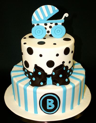 Two Tier White And Blue Baby Shower Cake With Black Bow And Baby
