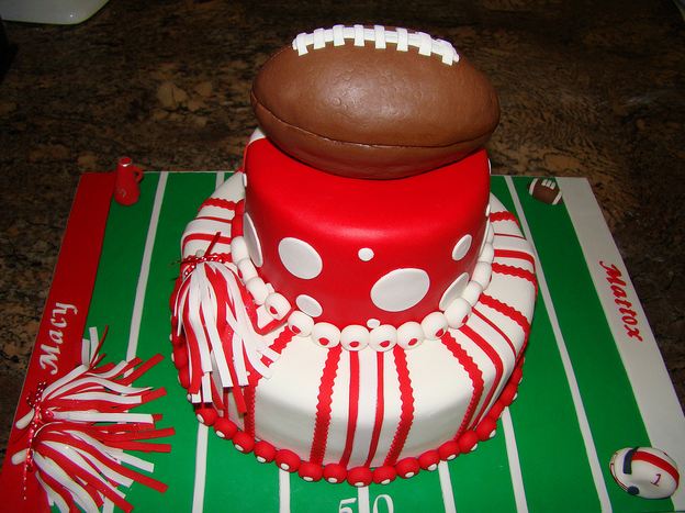 Red and white two tier football theme cake with football and field.JPG