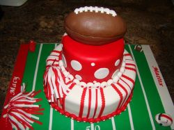 Red and white two tier football theme cake with football and field.JPG