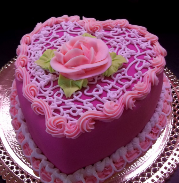 Hot pink heart shaped cakes with flowers cake decor.PNG