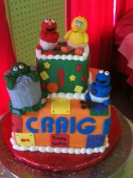 Two tier baby Sesame theme birthday cake for one year old.JPG