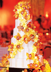Roselyn Sanchez wedding cake with fresh flowers in bright yellow and orange_Beverly Hills wedding cakes picture.PNG