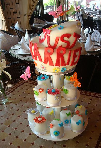 Just married wedding cake with mini cakes for first two tiers.JPG