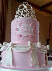 Two tier pink birthday cake with white bows for girl.JPG