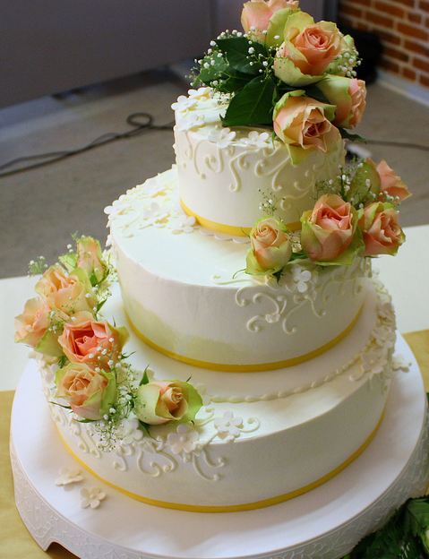 Tri-tier white round wedding cake with offset stacking and fresh pink roses.JPG