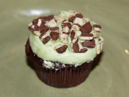 Chocolate cupcake with cookie chunks and cream on top.JPG