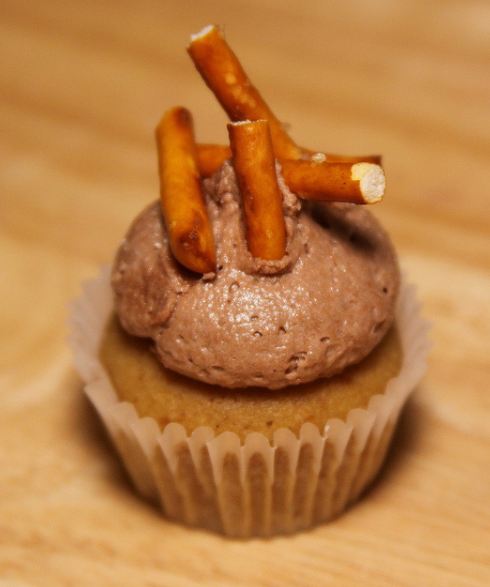Chocolate cupcake with pretzel pieces on top.JPG
