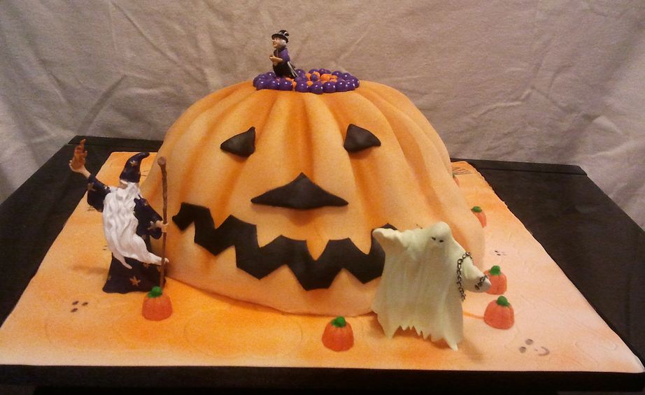Halloween pumpkin cake with ghost and wizard and witch.JPG