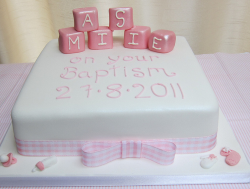 White square girl baptism cake with pink cubes and letters.PNG