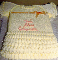 Dress baptism cake in cream color with pink cake decors.PNG