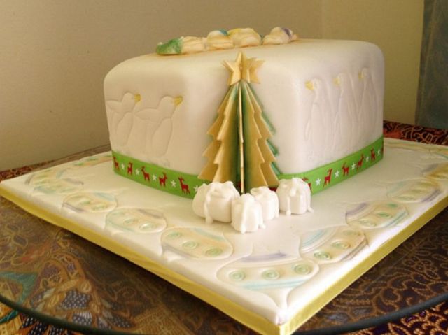 Christmas cake in white with tree and penguins and ornaments.JPG